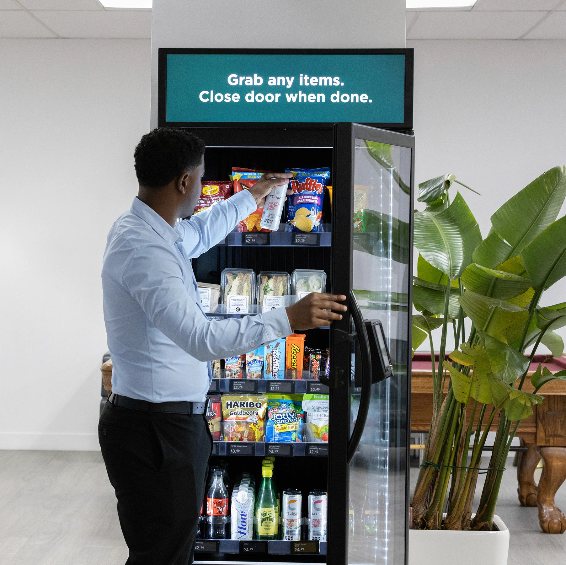 Person grabbing an item from a smart vending machine
